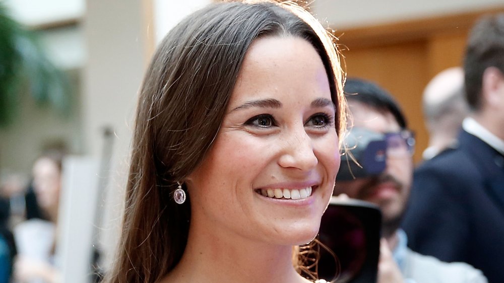 Pippa Middleton sonriendo mientras mira a un lado