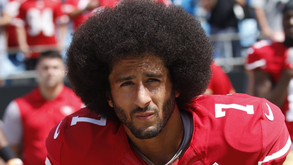 Colin Kaepernick kneeling in protest during the national anthem at a September 2016 San Francisco 49ers game 