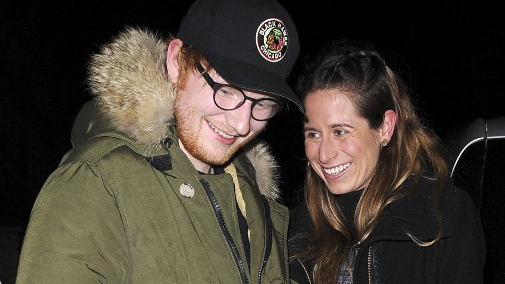 Ed Sheeran and Cherry Seaborn smiling while waiting for their car