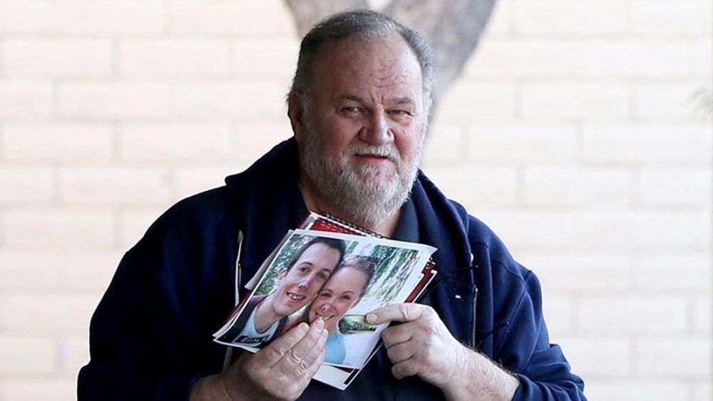 Thomas Markle sosteniendo fotógrafos