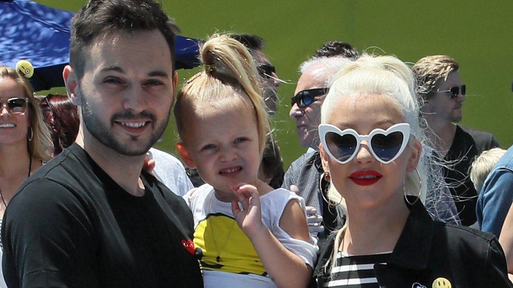 Matthew Rutler, Christina Aguilera, and their daughter Summer Rain at the premier of The Emoji Movie