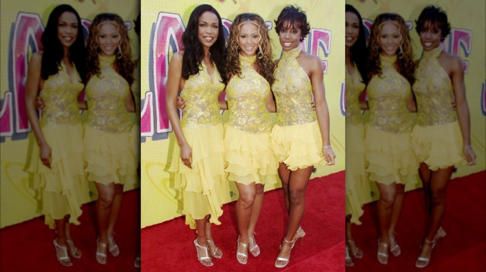 Michelle Williams, Beyoncé y Kelly Rowland con trajes amarillos a juego, posando en la alfombra roja