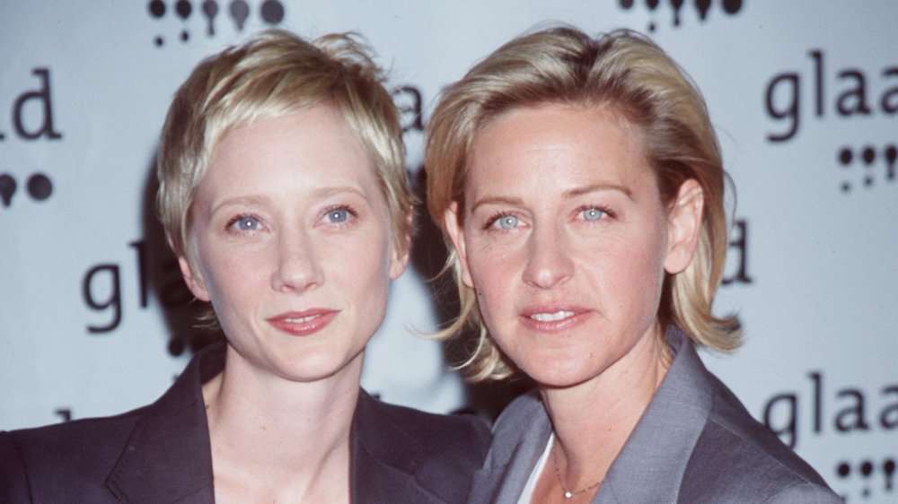 Anne Heche, Ellen DeGeneres posando juntos, ambos con expresiones serias