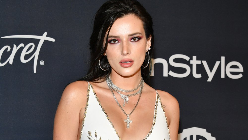 Bella Thorne con el pelo negro y sombra de ojos rojo