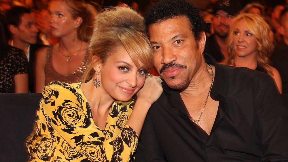 Nicole Richie abrazando a Lionel Richie mientras estaba sentado