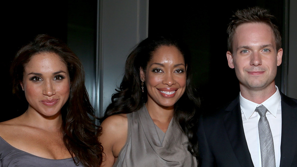 Meghan Markle, Gina Torres y Patrick J. Adams sonriendo