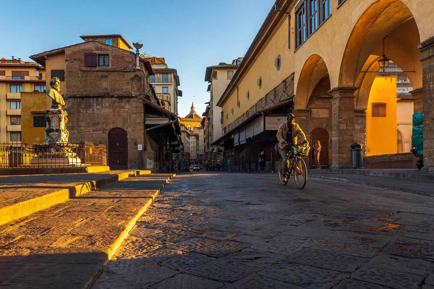 Un ciclista en el puente Ponte Vecchio temprano en la mañana