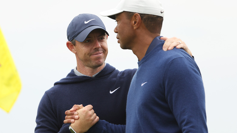 Rory McIlroy y Tiger Woods se dan la mano